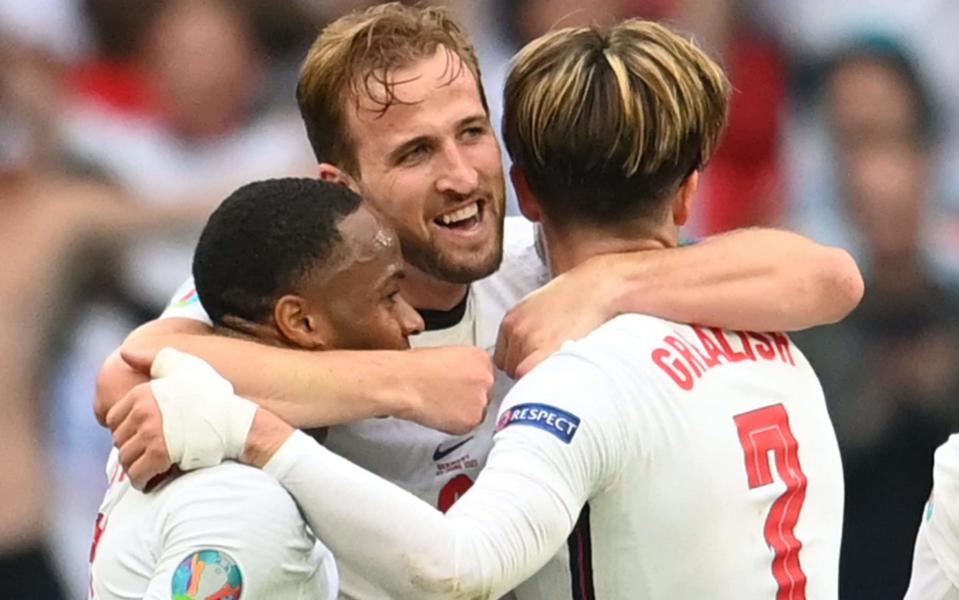 Harry Kane celebrates with Raheem Sterling and Jack Grealish after scoring England's second goal - AFP