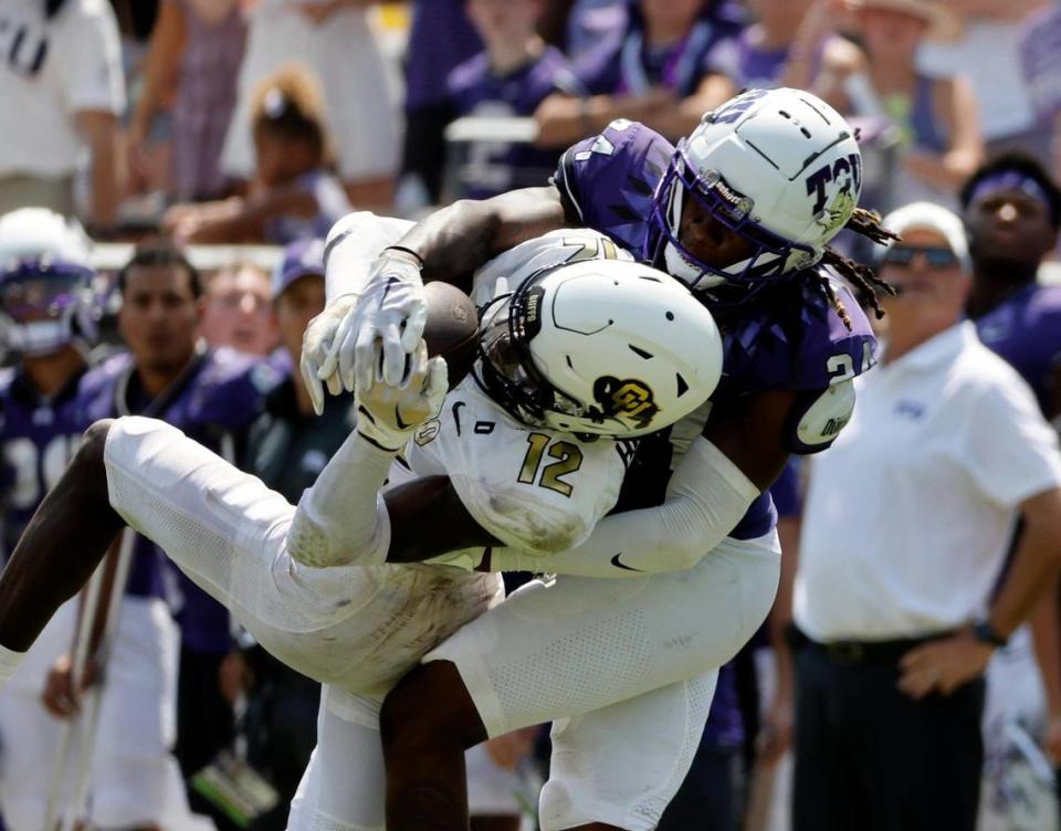 Colorado wide receiver Travis Hunter comes down with a curtail catch defended by TCU corner back Avery Helm (24) in the second half of a NCAA football game at Amon G. Carter Stadium in Fort Worth,Texas, Saturday Sept. 02, 2023. Colorado defeated TCU 45-42. (Special to the Star-Telegram Bob Booth)