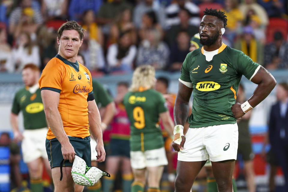 Rival captains Australia's Michael Hooper, left, and South Africa's Siya Kolisi react during the Rugby Championship test match between the Springboks and the Wallabies in Brisbane, Australia, Saturday, Sept. 18, 2021. (AP Photo/Tertius Pickard)