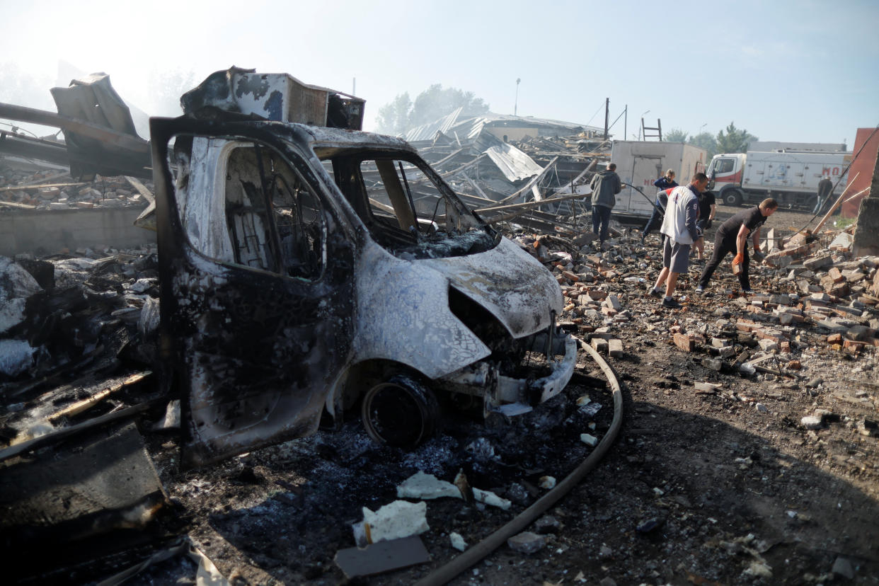 Ukrainians remove what's left after a Russian strike in Kramatorsk