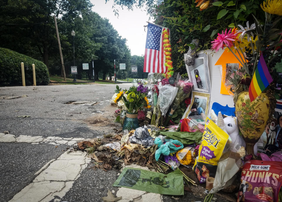 A makeshift memorial to Katherine Janness is seen at the entrance to Piedmont Park on Sunday, Aug. 1, 2021, in Atlanta. Janness, 40, was found stabbed to death in the park in the early hours of July 28. Police say her dog was also killed at the scene. No arrests have been made and the FBI is assisting local authorities in the case. (AP Photo/Ron Harris)