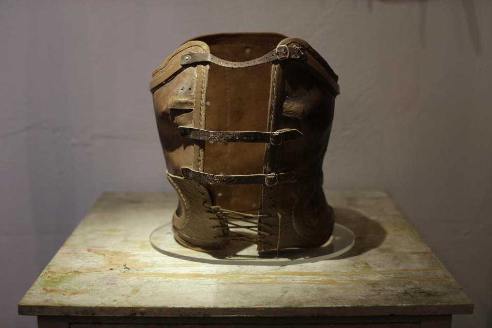 A leather corset that belonged to late Mexican artist Frida Kahlo is displayed at the Frida Kahlo museum in Mexico City, Tuesday, Oct. 2, 2012. A full collection from Kahlo's wardrobe will go on public display Nov. 22 in Mexico City after being locked for nearly 50 years in her armoires and dressers: jewelry, shoes and clothes that still carry the scent of the late artist's perfume and cigarette smoke or stains from painting. Her loose blouses covered the stiff corsets she wore for back pain. (AP Photo/Dario Lopez-Mills)