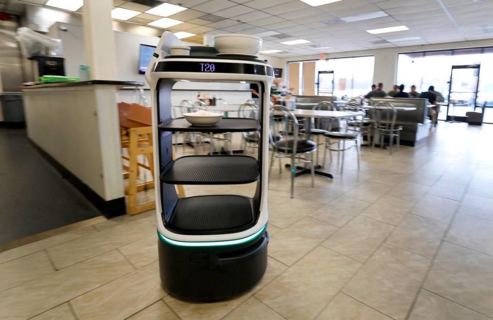 A Servi Delivery Robot manufactured by Bear Robotics delivers an order to lunchtime guests at Pho 919 in Morrisville Friday, Feb. 23, 2024. Servi debuted at the Morrisville restaurant a few weeks ago. It self steers at a walking pace. Employees simply tap table numbers on Servi’s screen and tell it whether to bring meals or take away plates.