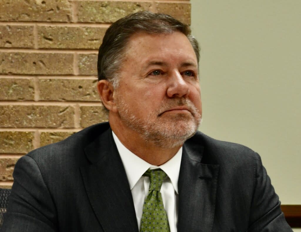 Attorney General Gentner Drummond is pictured sitting at a conference table