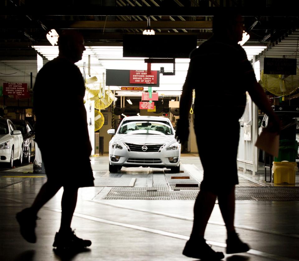 FILE - Workers at the Nissan plant in Smyrna, Tenn., walk by a Nissan Altima sedan, May 15, 2012. A group of 75 employees out of the thousands who work at a Nissan assembly plant in Tennessee will finally vote Thursday, March 16, 2023, on whether to form a union.