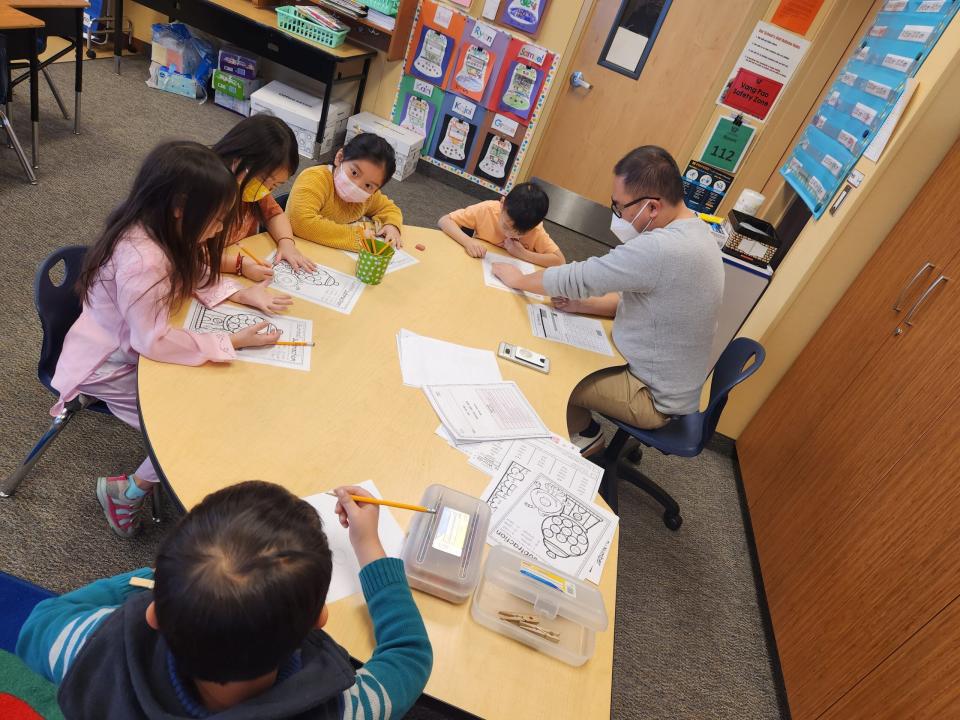 Fourth grade teacher David Thao works with students in the Hmong Dual Language Immersion program.