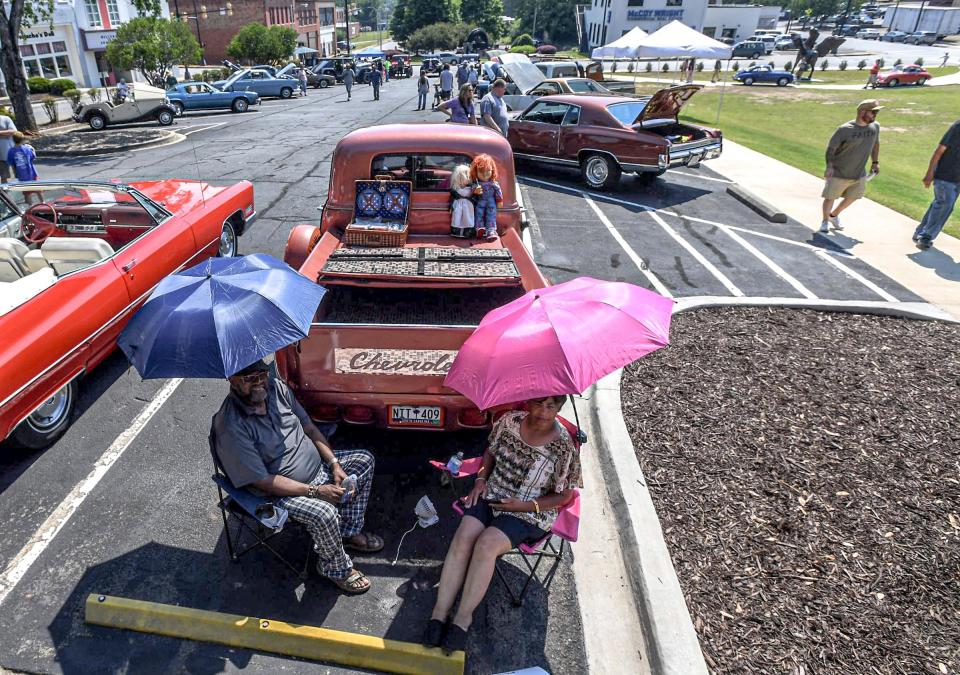 John Copeland and Kitty Copeland of Belton relax near their 1951 Chevy Truck, part of nearly 400 cars, trucks, land speed vehicle and a tractor on display at the Main Street Program's 24th annual Piedmont Natural Gas Day B4 Father's Day Car Show in Anderson, S.C. Saturday, June 15, 2024.