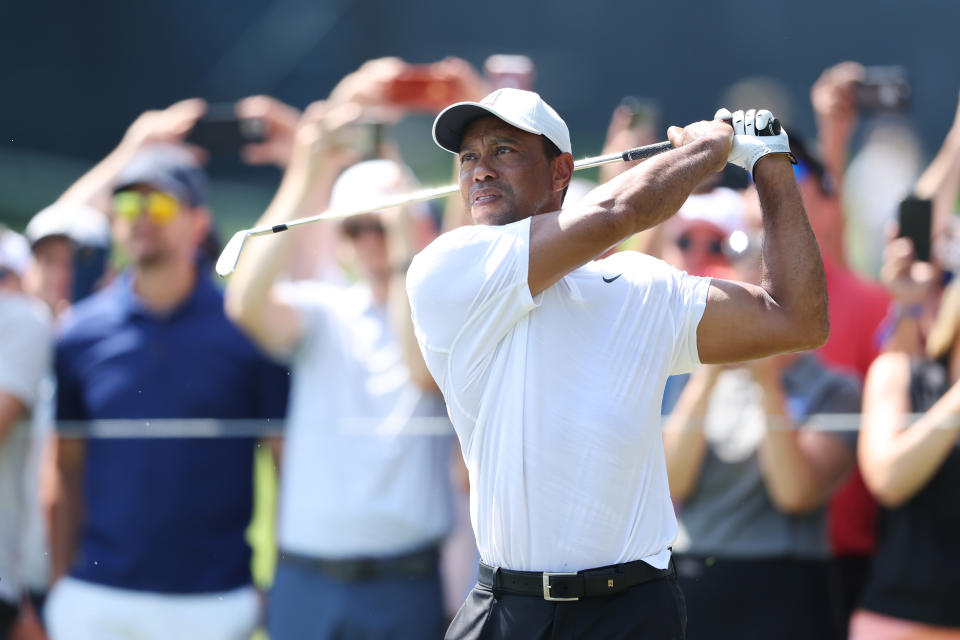 Pictured here, fans watch on as Tiger Woods plays a shot during a practice round for the 2022 PGA Championship. 