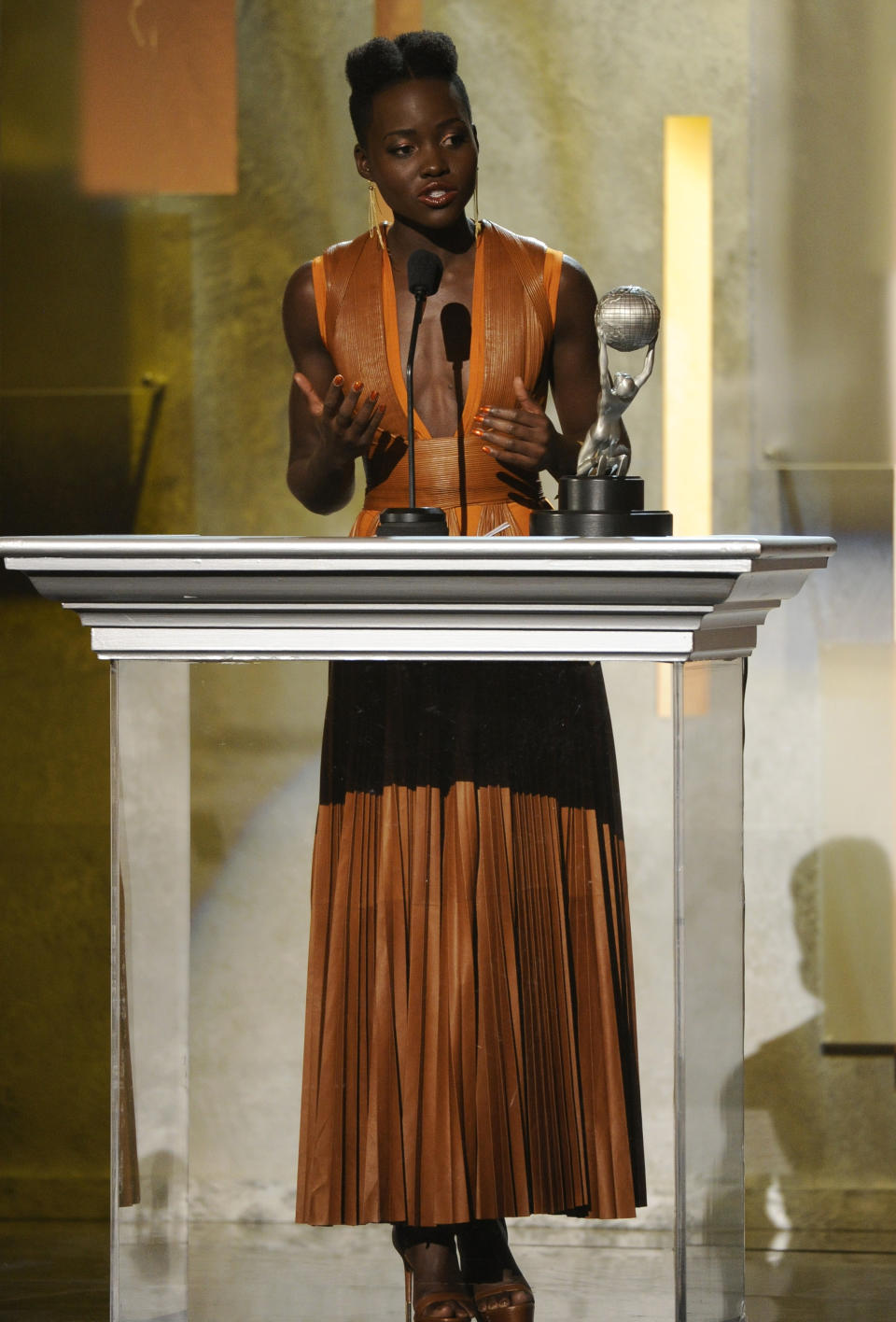 Lupita Nyong'o accepts the award for outstanding supporting actress in a motion picture for "12 Years a Slave" at the 45th NAACP Image Awards at the Pasadena Civic Auditorium on Saturday, Feb. 22, 2014, in Pasadena, Calif. (Photo by Chris Pizzello/Invision/AP)