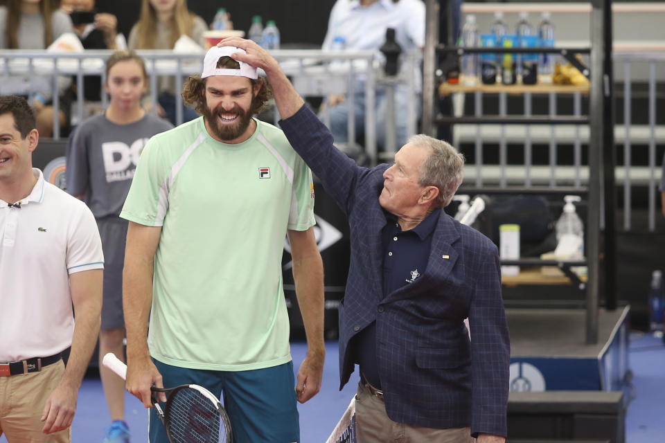 Former President George W. Bush, pictured here joking with Reilly Opelka at the Dallas Open.