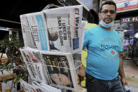 A man walks past newspapers headlining on former Algerian President Abdelaziz Bouteflika's death, in Algiers, Sunday, Sept.19, 2021. Algeria's leader declared a three-day period of mourning starting Saturday for former President Abdelaziz Bouteflika, whose 20-year-long rule, riddled with corruption, ended in disgrace as he was pushed from power amid huge street protests when he decided to seek a new term. Bouteflika, who had been ailing since a stroke in 2013, died Friday at 84. (AP Photo/Fateh Guidoum)