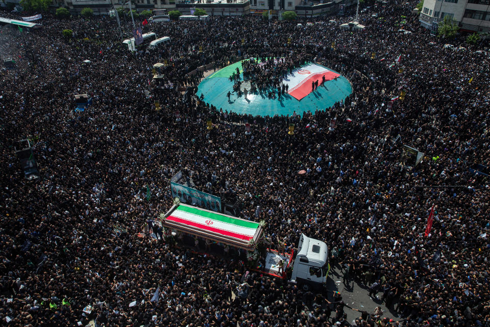 A truck carrying the coffins of President Ebrahim Raisi, Foreign Minister Hossein Amir Abdollahian and others is driven through a throng of mourners during a funeral procession in Tehran on May 22, 2024. <span class="copyright">Arash Khamooshi—The New York Times/Redux</span>