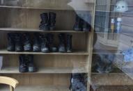 Workers' boots are seen through a window at Shuto Kogyo's dormitory for workers in Tome, Miyagi prefecture, December 20, 2013. (REUTERS/Antoni Slodkowski)