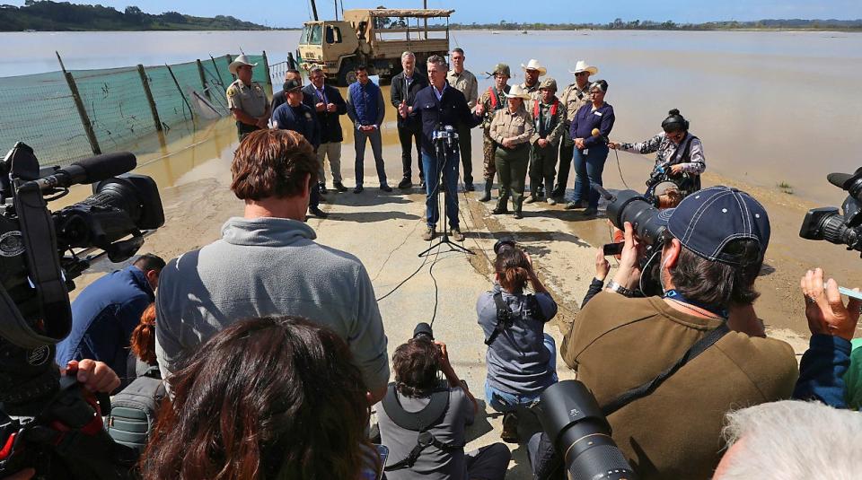 California Gov. Gavin Newsom next to a flooded field in Pajaro, California on March 15, 2023.