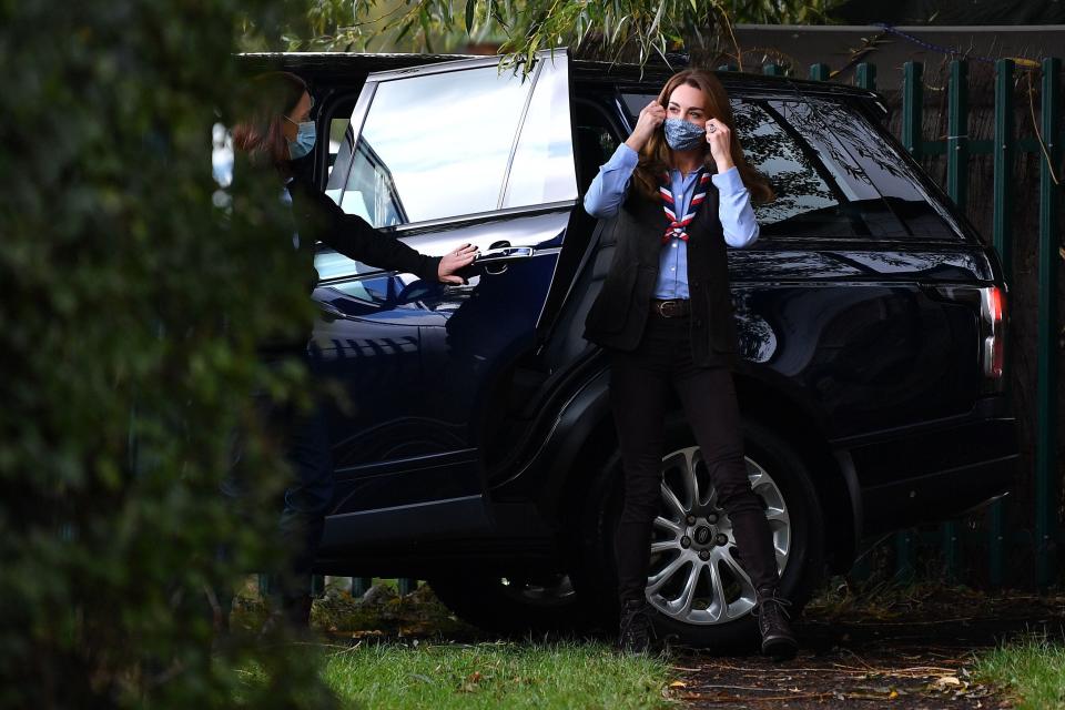 Britain's Catherine, Duchess of Cambridge, removes her mask, worn due to COVID-19, as she arrives to visit to a Scout Group in Northolt, northwest London on September 29, 2020, where she joined Cub and Beaver Scouts in outdoor activities.