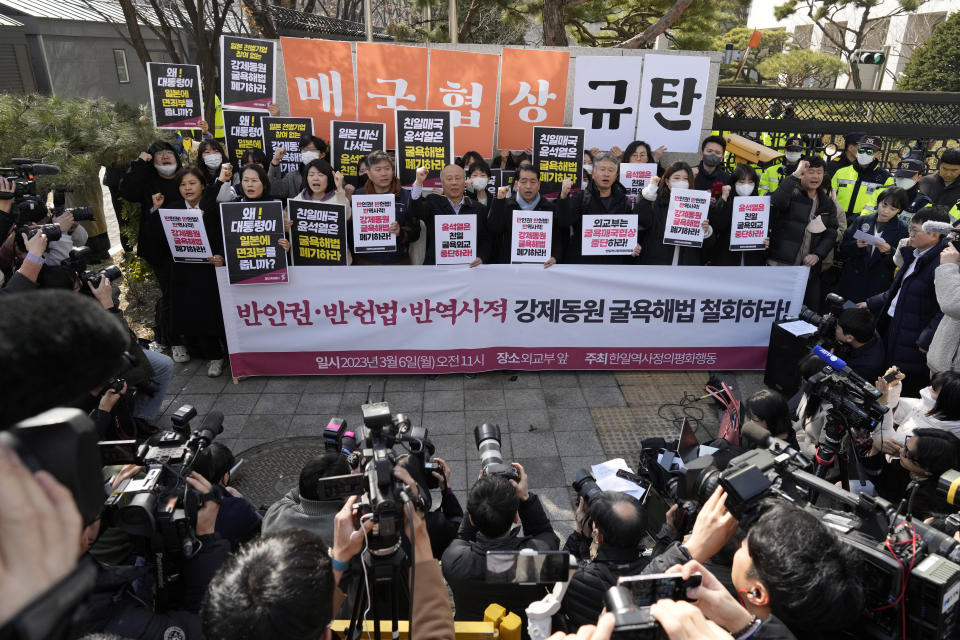 Members of civic groups shout slogans during a rally against the South Korean government's announcement of a plan over the issue of compensation for forced labors, in front of the Foreign Ministry in Seoul, South Korea, Monday, March 6, 2023. South Korea on Monday announced a contentious plan to raise local civilian funds to compensate Koreans who won damages in lawsuits against Japanese companies that enslaved them during Tokyo's 35-year colonial rule of the Korean Peninsula. A banner reads "Discards humiliating solution to forced labor issue." (AP Photo/Lee Jin-man)