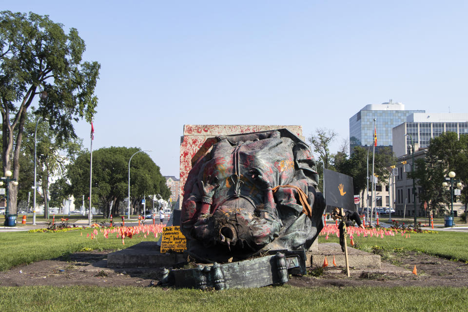 A headless statue of Queen Victoria is seen overturned and vandalized at the provincial legislature in Winnipeg, Friday, July 2, 2021. Her statue and a statue of Queen Elizabeth II were toppled on Canada Day during demonstrations concerning Indigenous children who died at residential schools. (Kelly Geraldine Malone/The Canadian Press via AP)