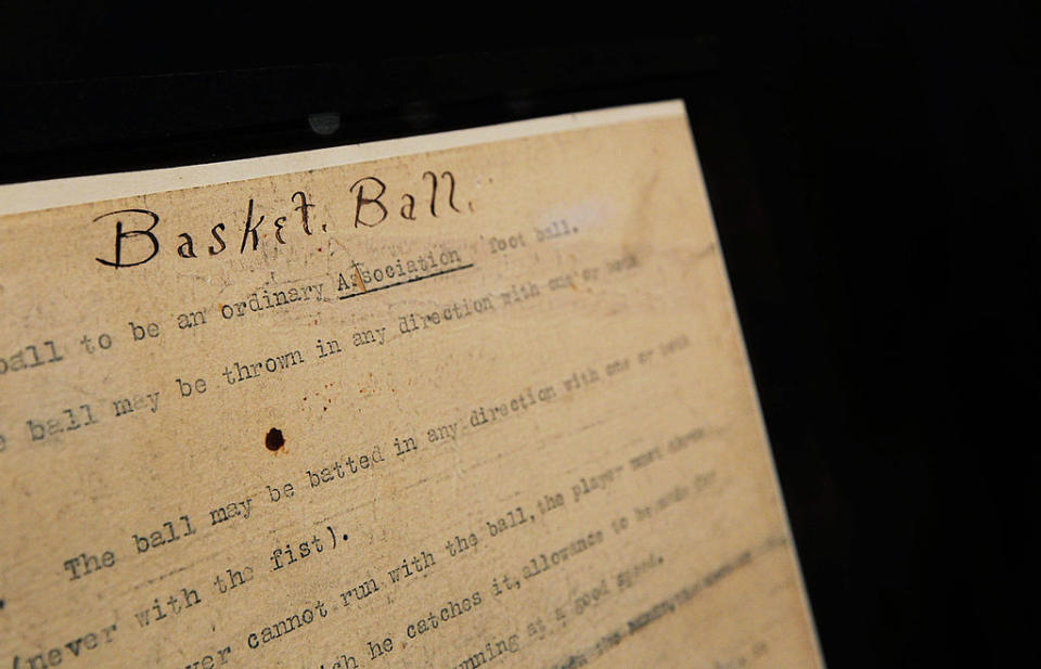 Old document labeled "Basket Ball" with faded text and a visible hole, detailing early rules of the game