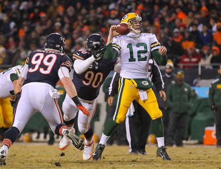 Dec 29, 2013; Chicago, IL, USA; Chicago Bears defensive end Julius Peppers (90) hits Green Bay Packers quarterback Aaron Rodgers (12) and causes a fumble during the second quarter at Soldier Field. Mandatory Credit: Dennis Wierzbicki-USA TODAY Sports