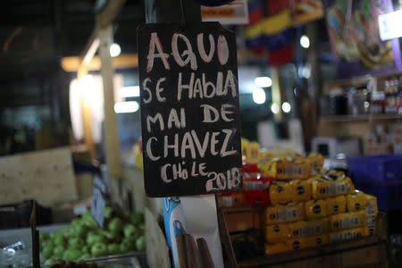 A banner that reads, "Here we talk ill of Chavez" is seen in La Vega market in Santiago, Chile, May 10, 2018. Picture taken May 10, 2018. REUTERS/Ivan Alvarado
