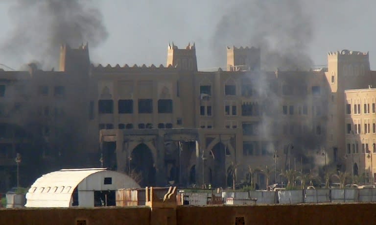 Smoke billows from the Al-Qasr hotel in Aden's western suburbs after it was hit by a rocket attack on October 6, 2015