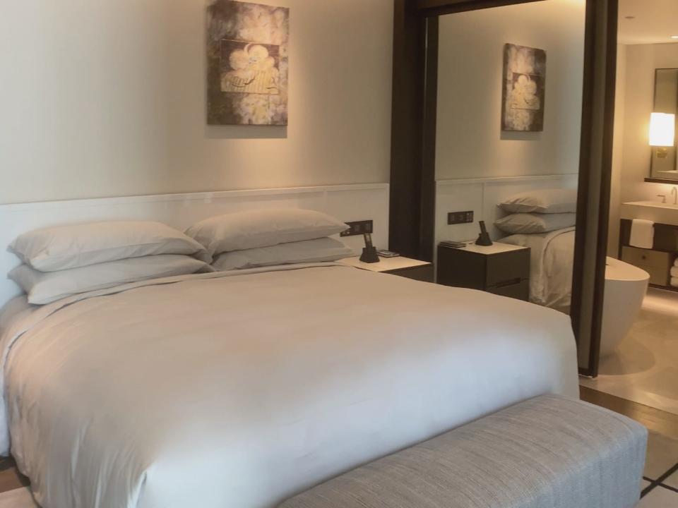 View of king-size bed and bathroom in a room in the Capella Sydney Hotel, Paul Oswell, Capella Sydney Hotel review