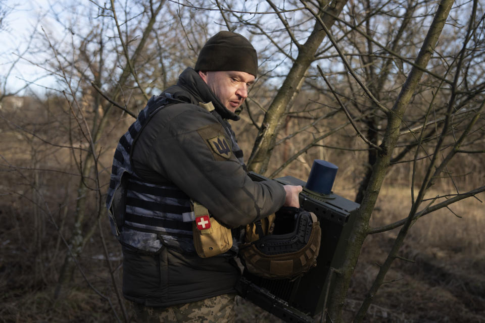 A Ukrainian soldier installs an electronic warfare system to quell Russian drones at the front line, near Bakhmut, Donetsk region, Ukraine, Monday, Jan. 29, 2024. Ukrainian forces are increasingly resorting to an age-old tactic — intelligence gleaned from radio intercepts — in a desperate effort to preserve their most vital resources. The painstaking work of eavesdropping is part of a larger effort to beef up and refine electronic warfare capabilities so that soldiers can be warned earlier of impending attacks, while having the battlefield intelligence needed to make their own strikes more deadly. (AP Photo/Efrem Lukatsky)