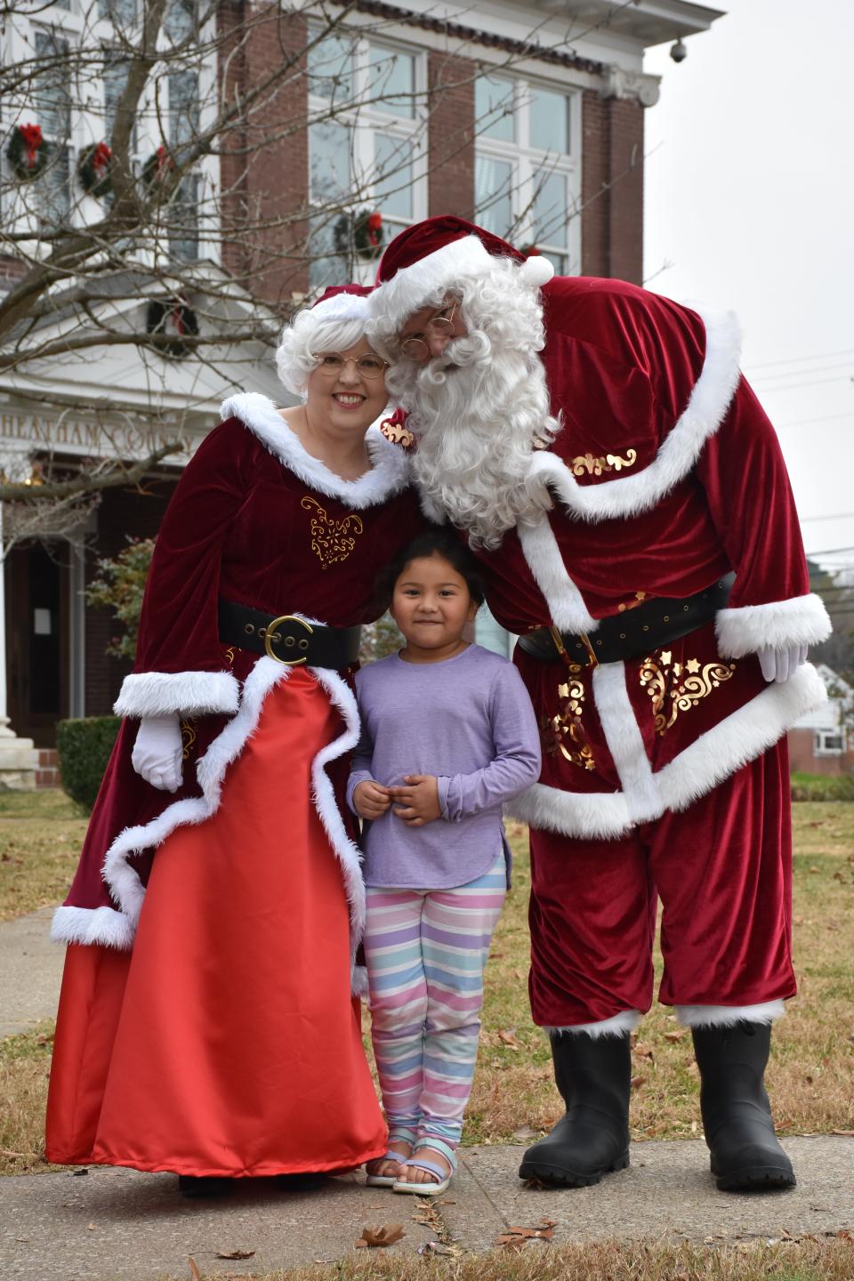 Angela Mares posed for her photo with Mr. and Mrs. Claus.