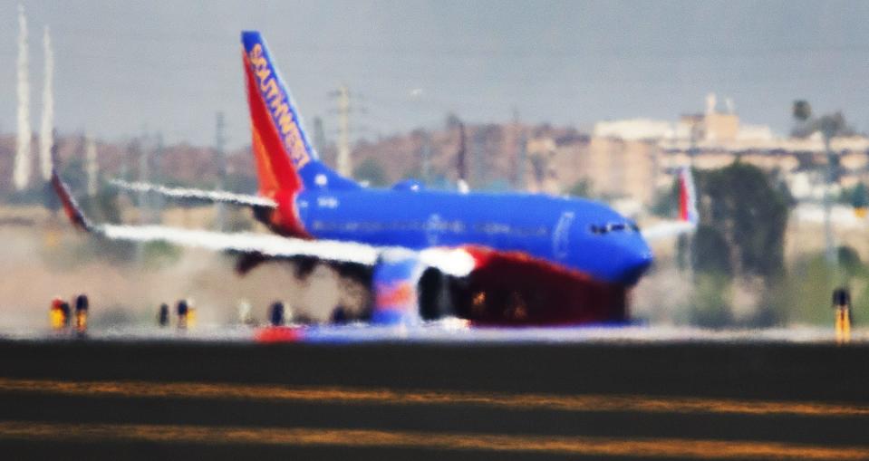 The right engine of a Southwest Airlines 737 appears to melt off the wing from the mirage of heat rising from the runway as it lands at Sky Harbor International Airport as the temperature hit 119 degrees, Tuesday, June 20, 2017.