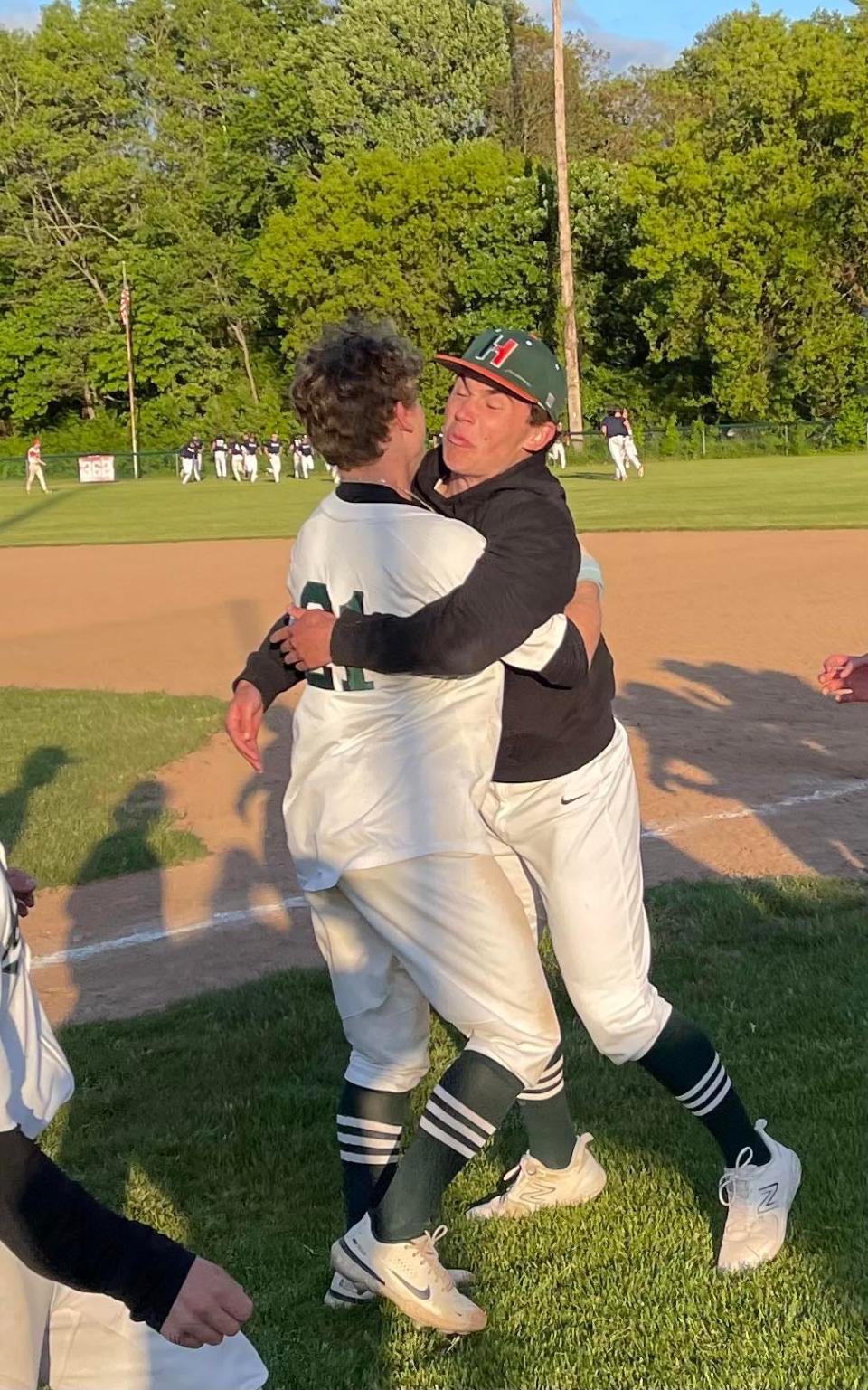 Hopkinton's Dylan Ruff (21) gets a hug after hitting the game-winning single with two outs in the bottom of the eighth inning against Franklin Thursday in the Pedroli Classic.