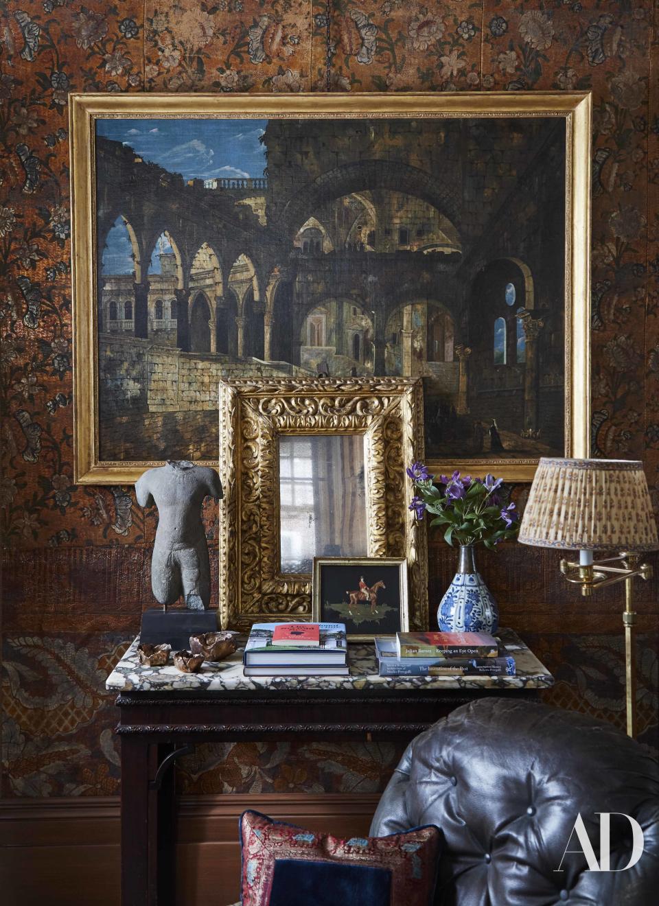 An 18th-century Venetian painting hangs over an 18th-century English table in the living room. Ancient Khmer bust; small brass bowls by Osanna Visconti; Louis XIV mirror; small 19th-century painting; 18th-century Chinese vase with Turkish silver neck.