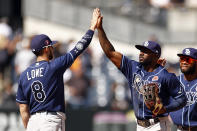 Tampa Bay Rays left fielder Randy Arozarena high-fives second baseman Brandon Lowe (8) after defeating the New York Yankees in a baseball game on Monday, May 31, 2021, in New York. The Rays won 3-1. (AP Photo/Adam Hunger)