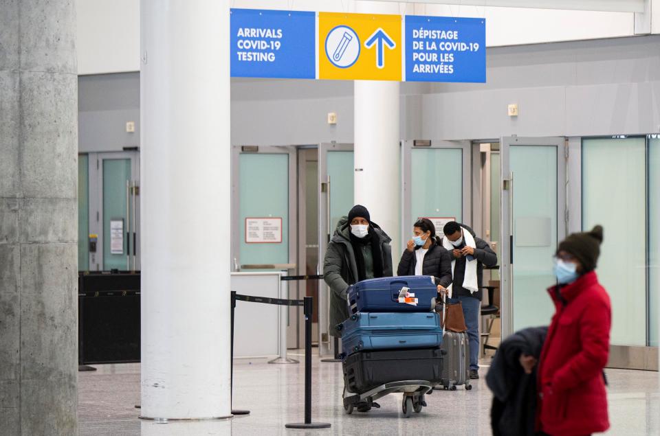 Travelers wearing face masks are seen at the arrivals hall of Toronto Pearson International Airport in Mississauga, Ontario, Canada, on April 1, 2022. Border measures were eased in Canada on Friday as fully vaccinated travelers no longer need pre-arrival COVID-19 testing to enter Canada either by land or air. (Photo by Zou Zheng/Xinhua via Getty Images)