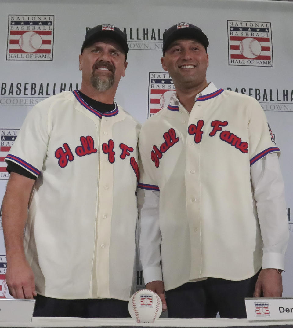 New York Yankees shortstop Derek Jeter, right, and Colorado Rockies outfielder Larry Walker pose after receiving their Baseball Hall of Fame Jerseys, Wednesday Jan. 22, 2020, during a news conference in New York. Jeter and Walker will both join the 2020 Hall o Fame class. (AP Photo/Bebeto Matthews)