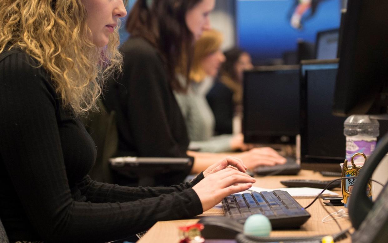 Women are often forced to wear jackets and jumpers to stay warm in overly air-conditioned offices  - PA