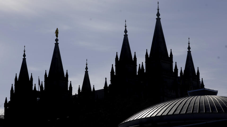 The Salt Lake Temple of The Church of Jesus Christ of Latter-day Saints is shown Saturday, April 4, 2020, in Salt Lake City. The twice-annual conference kicked off Saturday without anyone attending in person and top leaders sitting some 6 feet apart inside an empty room as the faith takes precautions to avoid the spread of the coronavirus. A livestream of the conference showed a few of the faith's top leaders sitting alone inside a small auditorium in Salt Lake City, Normally, top leaders sit side-by-side on stage with the religion's well-known choir behind them and some 20,000 people watching. (AP Photo/Rick Bowmer)