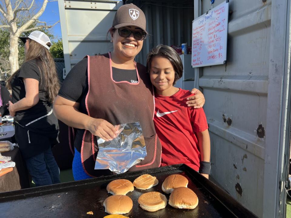 Rocio Velazquez, the mother of Crespi sophomore Diego Velazquez, works at the snack bar with younger son David by her side.