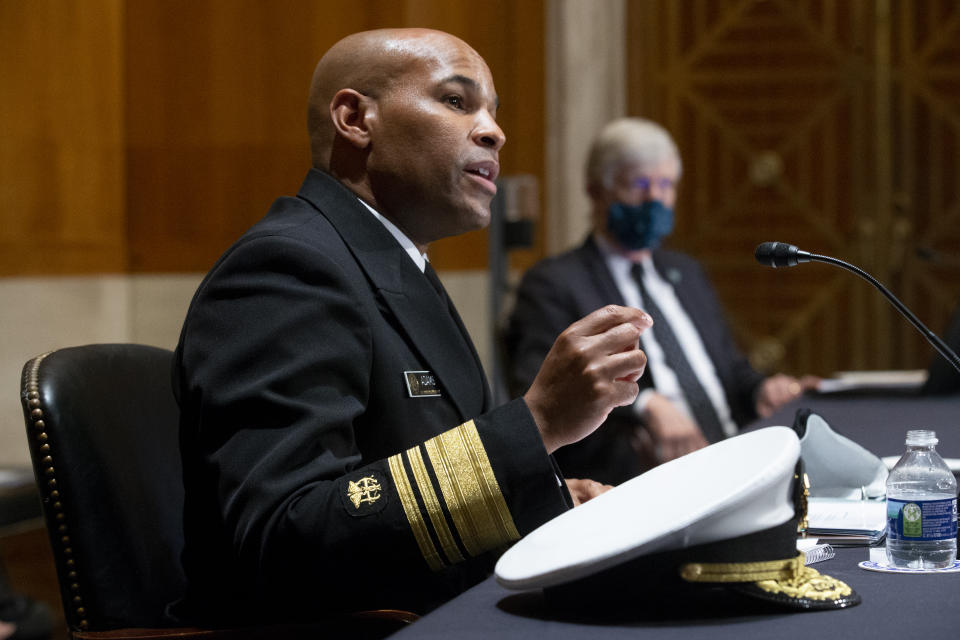 FILE - In this Sept. 9, 2020 file photo Surgeon General Jerome Adams, appears before a Senate Health, Education, Labor and Pensions Committee hearing on Capitol Hill, in Washington. Adams was cited for being in a closed Hawaii park in August while in the islands helping with surge testing amid a spike in coronavirus cases, according to a criminal complaint filed in court. (Michael Reynolds/Pool via AP,File)