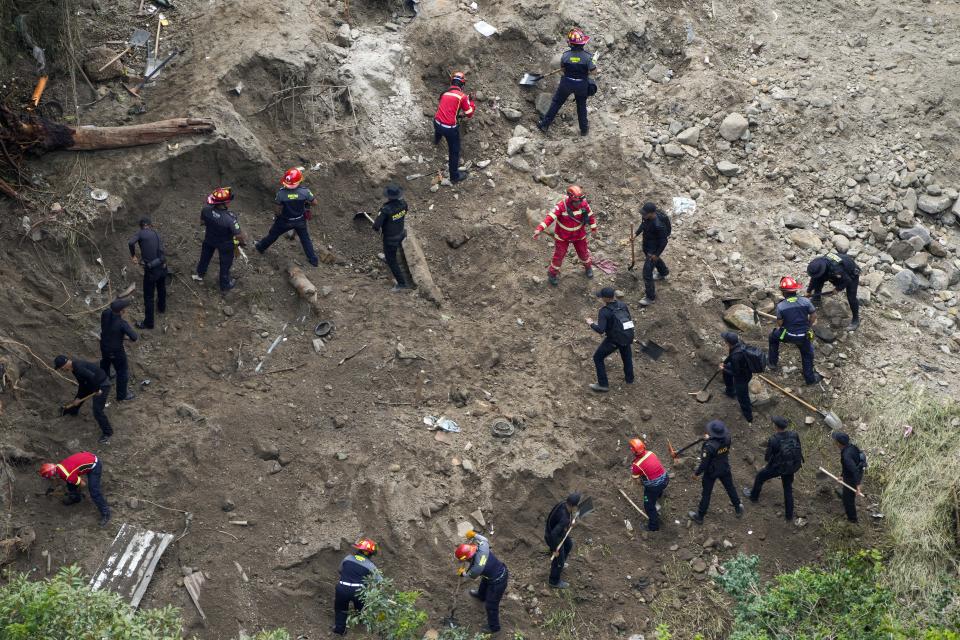 Police and firefighters dig for survivors after homes of the "Dios es fiel," or God is Loyal shanty town were swept away overnight by a swollen Naranjo River, on the outskirts of Guatemala City, Monday, Sept. 25, 2023. (AP Photo/Moises Castillo)