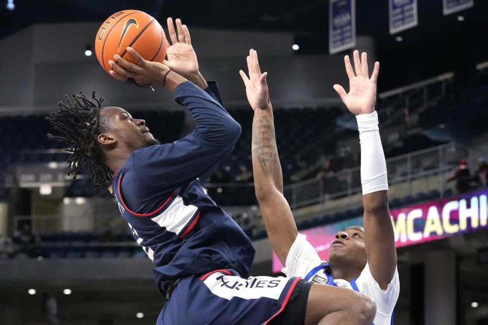 Connecticut guard Tristen Newton, left, drives to the basket against DePaul guard Elijah Fisher during a game on Feb. 14.