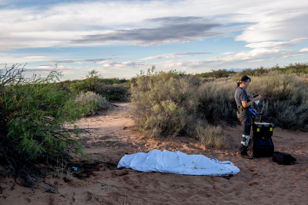 Laura Mae Williams, a field investigator for New Mexico's Office of the Medical Investigator, concludes her work gathering details in the death of a migrant in the desert about two miles north of the international boundary with Mexico on Sept. 13, 2023. This stretch in New Mexico is the hot spot in a record year of migrant deaths in the El Paso Border Patrol Sector.
