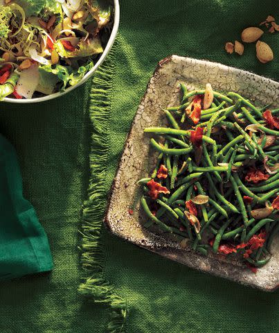 Gentl & Hyers Toss the green beans with a warm dressing of softened shallots, cider vinegar, and crisp bacon. <a href="https://www.realsimple.com/food-recipes/browse-all-recipes/green-beans-bacon-vinaigrette" data-component="link" data-source="inlineLink" data-type="internalLink" data-ordinal="1">Get the recipe</a>.