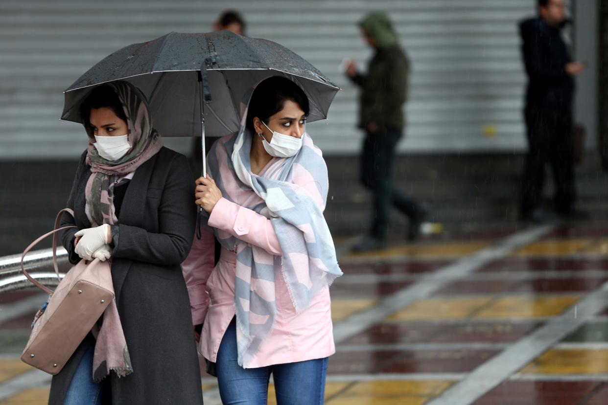 FILE PHOTO: Iranian women wear protective masks to prevent contracting coronavirus, as they walk in the street in Tehran, Iran February 25, 2020. WANA (West Asia News Agency)/Nazanin Tabatabaee via REUTERS 