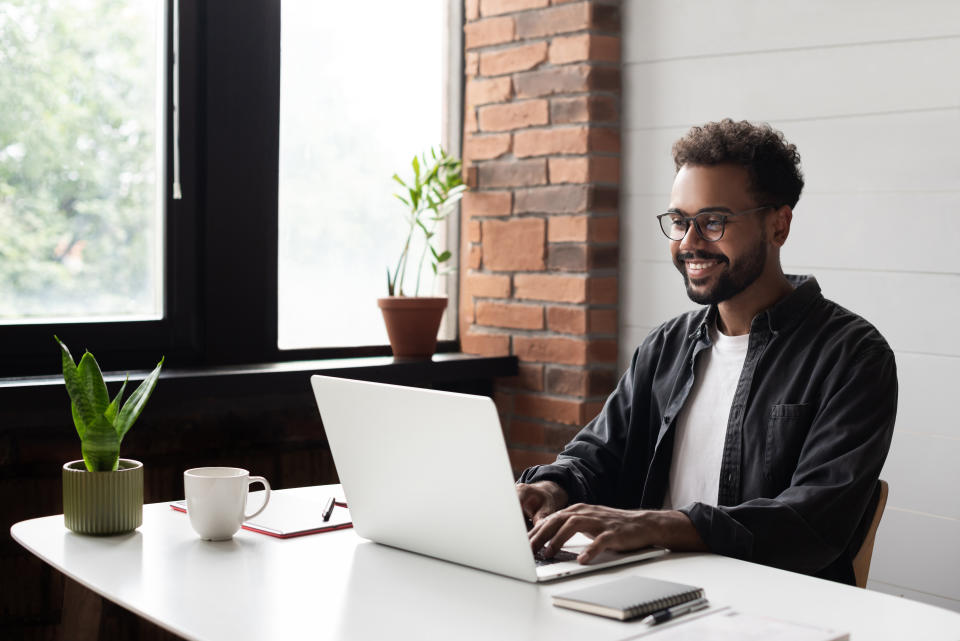 Businessman using laptop computer in office. Student studying online. Entrepreneur, creative occupation, work from home, freelance, online learning, studying concept. Distance education