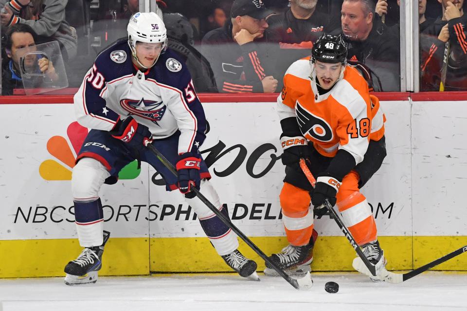 Dec 20, 2022; Philadelphia, Pennsylvania, USA; Columbus Blue Jackets left wing Eric Robinson (50) and Philadelphia Flyers center Morgan Frost (48) battle for the puck during the second period at Wells Fargo Center. Mandatory Credit: Eric Hartline-USA TODAY Sports