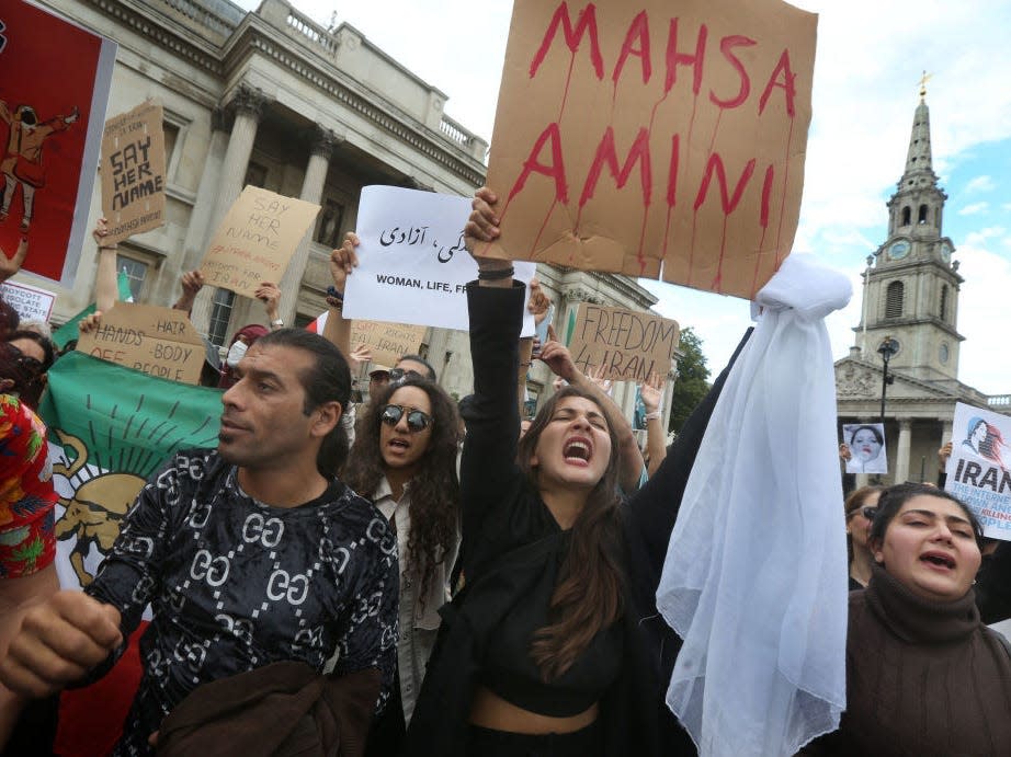 Protesters in Trafalgar Square hold signs aloft with Mahsa Amini's name on them on September 24, 2022 in London, England. Iranian Mahsa Amini fell into a coma and died after being arrested in Tehran by the morality police, for allegedly violating the countries hijab rules.