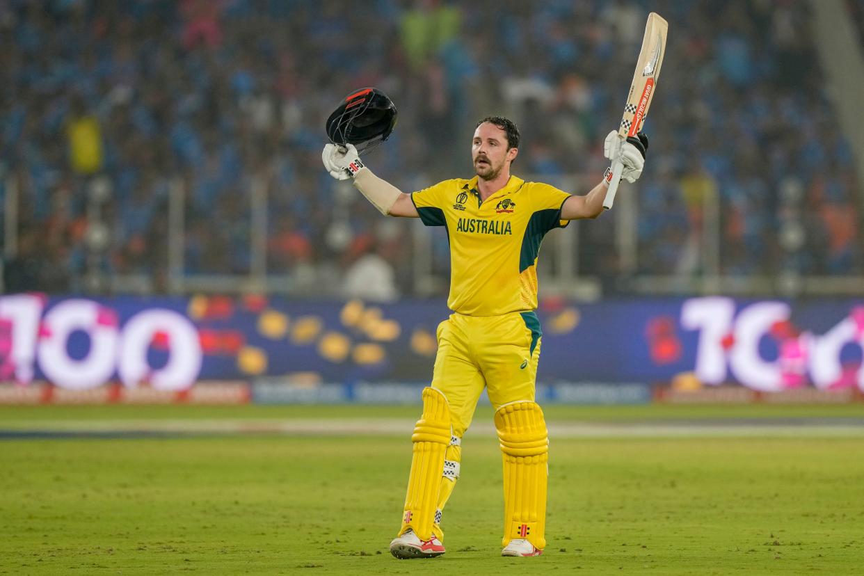 Travis Head raises his bat as he celebrates his century in the World Cup final (AP)