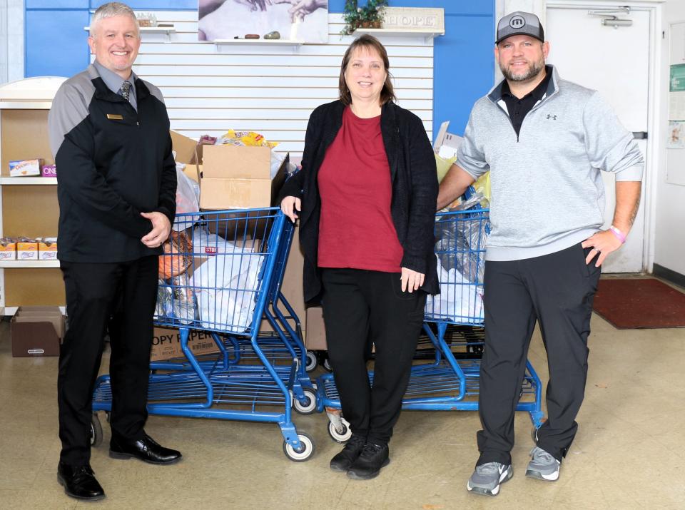 Pictured from left to right are Gus Harrison Correctional Facility Assistant Deputy Warden Andrew Johnson, Fishes & Loaves Pantry Manager Cheri Constable and Gus Harrison Employee Club President Matthew Randall. A recently held food donation drive by employees at Gus Harrison produced 611 pounds of food that was donated to the Adrian food pantry. The collection continued through the Thanksgiving holiday.