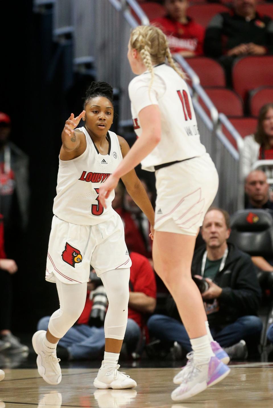 Louisville's Chrislyn Carr celebrates with Haley Van Lith after making a three against SIUE.Dec. 6, 2022