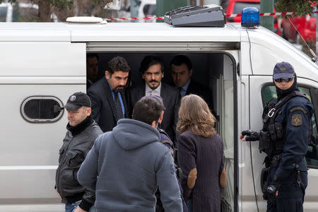 The eight Turkish soldiers, who fled to Greece in a helicopter and requested political asylum after a failed military coup against the government, are escorted by police officers as they arrive at the Supreme Court in Athens, Greece, January 26, 2017. REUTERS/Alkis Konstantinidis